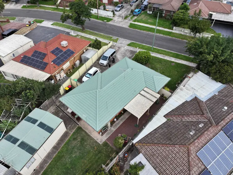 Aerial view of a street with a restored roof