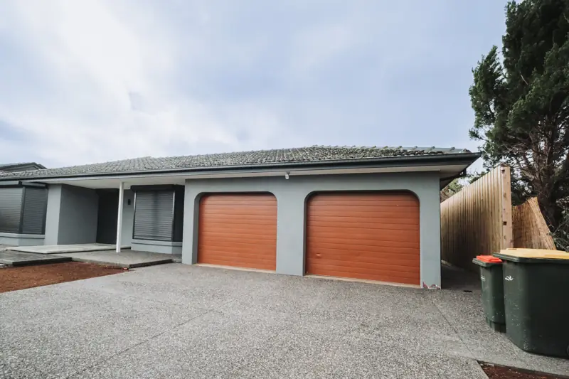 Gutter and fascia replacement on a rendered home with double garage