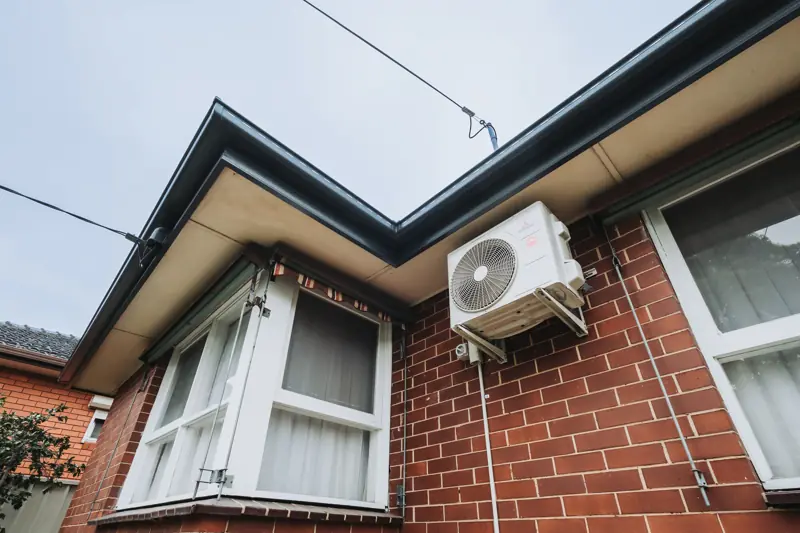 Replaced gutters wrapping a bay window