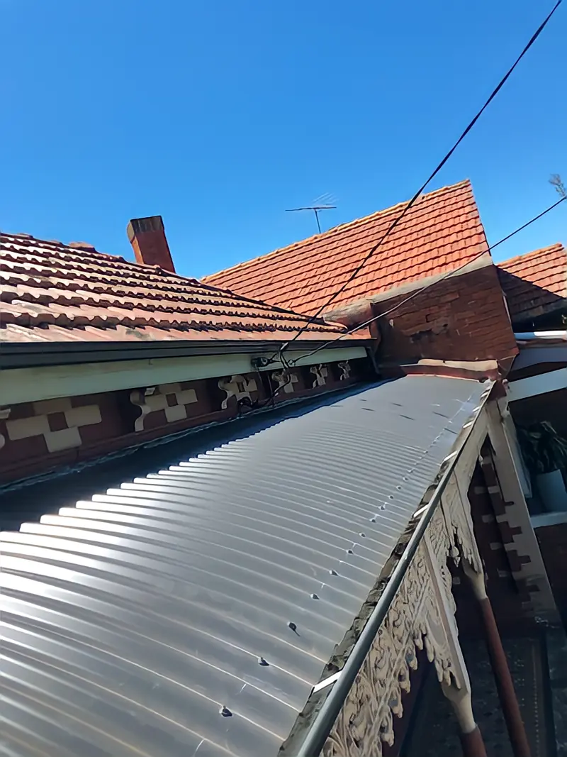 Terracotta roof with new Colorbond section